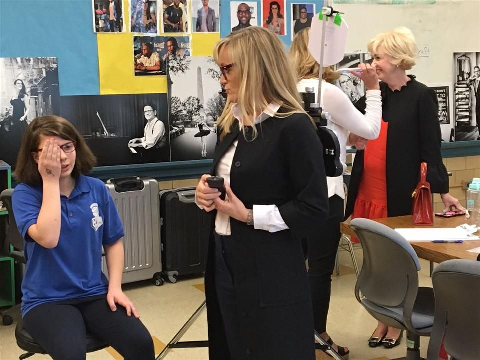  A doctor gives a student an eye exam.