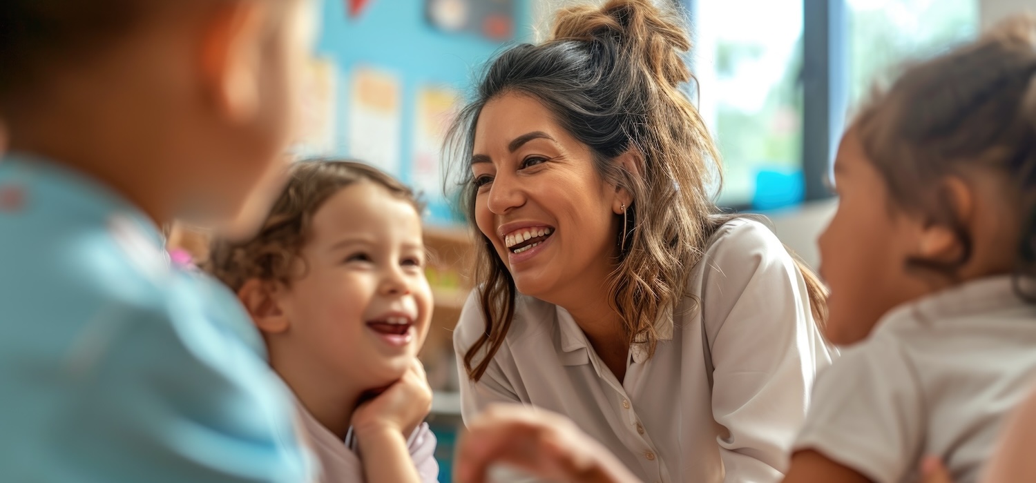 Teacher laughing with students