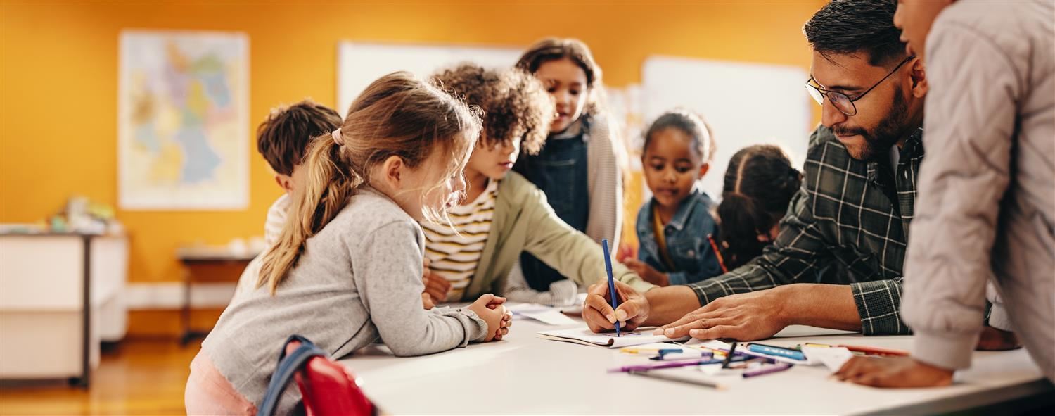 Teacher sitting with students